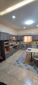 a large kitchen with a table in the middle at Shaaban M in Cairo
