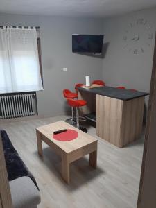 a living room with a table and a bar at Piso con terraza en Felechosa in Felechosa