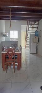 a kitchen with a table and chairs in a room at Residência Ilha Bela in São Luís