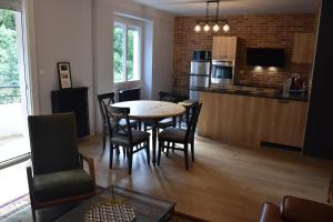 a kitchen and dining room with a table and chairs at Le Planard in Rodez