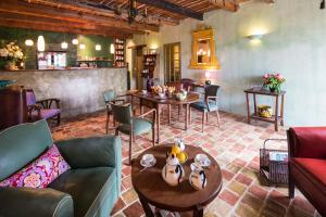 a living room with a couch and tables and chairs at Clos BB in Saint-Cyr-sur-Mer