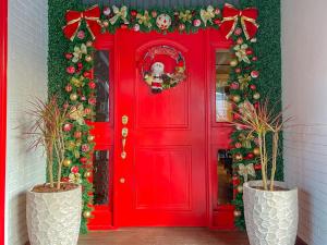 a red door with christmas decorations on it at Flame Hotel Boutique Canela in Canela
