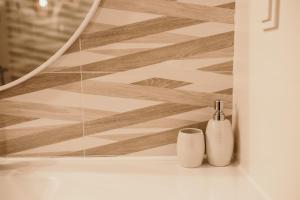 a bathroom with a mirror and two toothbrushes at Apartament Dar Pomorza 20m do Plaży Ustronie Apartments in Ustronie Morskie +36 photos