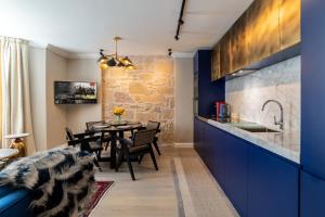 a kitchen and dining room with blue cabinets and a table at Pamper yourself in our DOUBLE SIZED copper tub -2 bedroom villa in Inverness