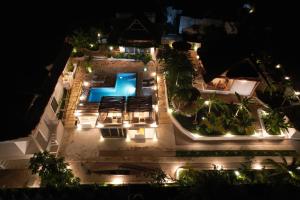 an aerial view of a house with a pool at night at ZANZIBAR TROPICAL SUNSET - Adults Only Boutique Hotel by Sofia Collection in Kiwengwa +95 photos