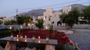 a stone building with a table with candles on it at Katafigi in Pirgos Dhirou