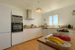 a kitchen with a bowl of fruit on a counter at Family villa with magnificent sea view for 11 people in Saint-Raphaël