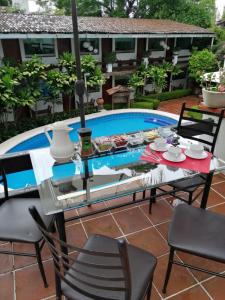 a table and chairs in front of a pool at Casa Dalinda in Valle de Bravo