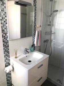 a bathroom with a white sink and a shower at Casa M's One bedroom apartment with communal pool in Matagorda in Puerto del Carmen