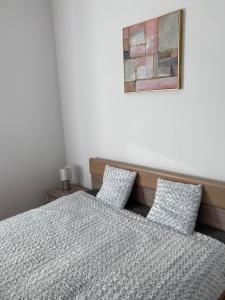a bedroom with a bed and two pillows at Kaunas Castle Apartments - One bedroom flat in Kaunas