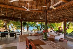 a restaurant with a table and chairs and the ocean at Casa Bonita and villas in Isla Mujeres