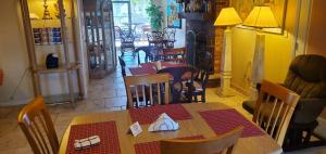 a dining room with a table and chairs and a room with tables and chairsktop at Conty's Motel in Naples