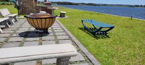 a blue bench and a light next to a body of water at Riverside Farm in eMalahleni +17 photos