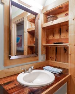 a bathroom with a sink and a mirror at Raven's Heart in West Yellowstone