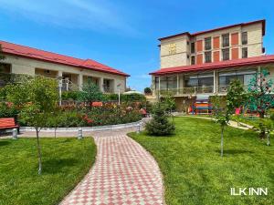 a brick walkway in front of a building at ILK INN HOTEL in Qusar