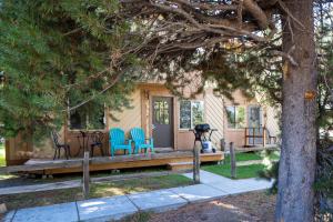 a house with a porch with blue chairs on it at Trapper 8 in West Yellowstone