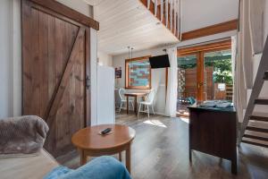 a living room with a sliding barn door and a table at Las Hermanas B in Guía de Isora