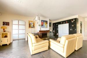 Una sala de estar con dos sillas y una mesa. en Beautiful Villa 8 guests - Pool Access in Mandelieu, en Mandelieu-la-Napoule