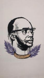 a drawing of a man with glasses on a wall at Amilcar Cabral Loft in Praia