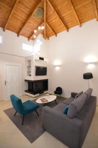 a living room with a couch and a table at Kameiros Treasure Villa in Kalavárda