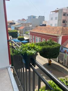a balcony with two potted plants on a railing at Amilcar Cabral Loft in Praia +3 photos