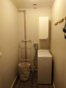a bathroom with a toilet and a trash can at Jokihelmi-apartment in Kannus +19 photos