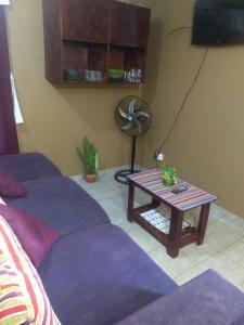 ein Wohnzimmer mit einem Sofa und einem Tisch in der Unterkunft Betel tu casa de refugio in Puerto Iguazú