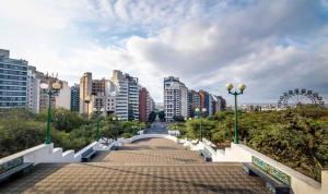 a bridge over a walkway in a city with buildings at Departamento Boutique en Nueva Córdoba in Cordoba
