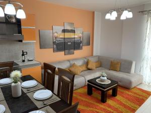 a living room with a couch and a table at Eka Luxury Two-Bedroom Penthouse in Durrës +17 photos