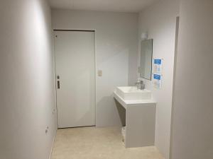 a white bathroom with a sink and a mirror at Koya TRIBE - Vacation STAY 81288v in Oishi