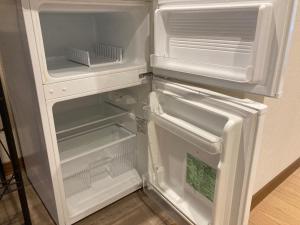 an empty refrigerator with its door open in a kitchen at Koya TRIBE - Vacation STAY 83398v in Oishi