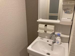 a bathroom with a sink and a mirror at Koya TRIBE - Vacation STAY 83398v in Oishi