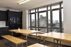 a room with two tables and a large window at Cwtsh Hostel Central Swansea, Social & Modern, Near Train Station in Swansea