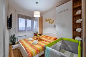 a small bedroom with a bed and a window at Apartments Mons in Vila Katalina in Zlatibor +38 photos