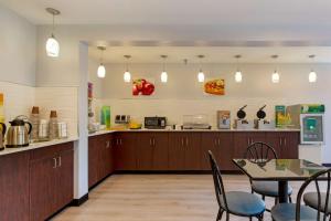 a kitchen and dining room with a table and chairs at Quality Inn in Lee