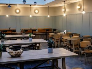 an empty restaurant with tables and chairs and lights at Comfort Hotel Børsparken in Oslo