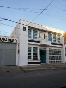 a white building with a medico sign on it at HOTEL IMPERIAL in Maicao
