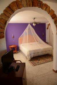 a bedroom with a bed with a net at Calamadonna Club Hotel in Lampedusa