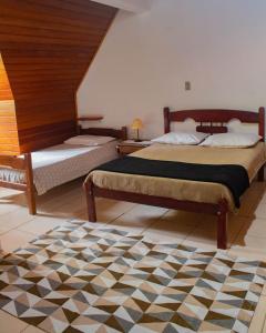 Ένα ή περισσότερα κρεβάτια σε δωμάτιο στο Apto Duplex confortável a apenas 2 km do Capivari
