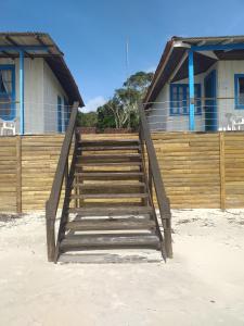 a wooden staircase leading to a house on the beach at Dona Quinota in Ilha do Mel +31 photos
