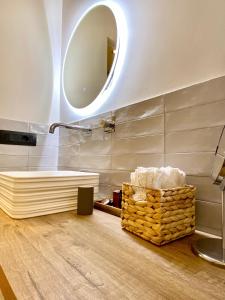 a bathroom with a tub and a mirror on the wall at VicomilleSuites Cagliari Adult Only in Cagliari +130 photos