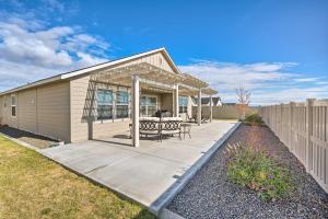 a house with a patio and a fence at Modern Caldwell House with Yard and Furnished Patio! in Caldwell