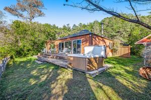 a tiny house with a deck in a yard at Cove House in Gualala