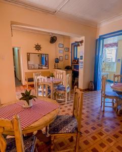 a dining room with a table and chairs at Pousada Aruans Casarão in Bragança