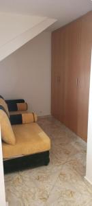 a living room with a couch in the corner of a room at Dar abd essalam in Moulay Yacoub