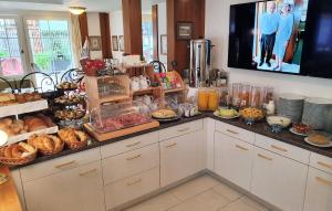 a kitchen with a bunch of food on a counter at Adler Hotel in Appenzell +50 photos