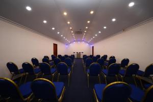 an empty room with blue chairs and a stage at BPR - Asgiriya ,Kandy in Kandy