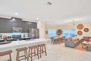 a kitchen and living room with a table and chairs at Royale Palm in Kissimmee