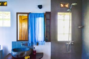 a bathroom with a sink and a shower at H2O Peaceful Yoga Resort in Gili Islands