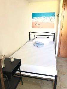 a bed in a room with a table and a picture at Stella's Maisonette in Siviri